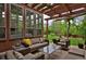 Inviting outdoor patio with comfortable seating, a pergola, and a lush backyard view at 8044 E 24Th Ave, Denver, CO 80238