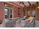 Cozy outdoor patio featuring comfortable seating, ambient lighting, and backyard views at 8044 E 24Th Ave, Denver, CO 80238