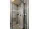 Modern shower featuring slate tile surround and glass door at 8044 E 24Th Ave, Denver, CO 80238