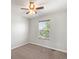 Cozy bedroom with a window, ceiling fan, and neutral color palette at 1428 S De Gaulle Ct, Aurora, CO 80018