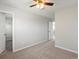 Well-lit bedroom with neutral walls, carpet, and access to a closet at 1428 S De Gaulle Ct, Aurora, CO 80018