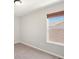 Well-lit bedroom featuring a window with a view and neutral wall tones at 1428 S De Gaulle Ct, Aurora, CO 80018