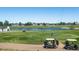 Golf course with pond, players, and golf carts at 1428 S De Gaulle Ct, Aurora, CO 80018