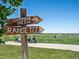 Wooden signpost indicating directions to chipping green and range tee at 1428 S De Gaulle Ct, Aurora, CO 80018