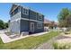 Two-story house with a gray exterior and a red door at 1428 S De Gaulle Ct, Aurora, CO 80018