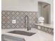 Contemporary kitchen sink with elegant faucet and patterned tile backsplash at 1428 S De Gaulle Ct, Aurora, CO 80018