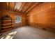 Bedroom with wooden walls and ceiling, carpet flooring and a window with a view of the outdoors at 121 Mary Beth Rd, Evergreen, CO 80439