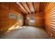 Bedroom with wooden walls and ceiling, carpet flooring and a window with a view of the outdoors at 121 Mary Beth Rd, Evergreen, CO 80439