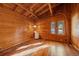 Bedroom with wooden walls and ceiling, wood flooring, window and light with a view of the outdoors at 121 Mary Beth Rd, Evergreen, CO 80439