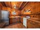 Rustic wood kitchen features tile floors, stainless steel refrigerator, and classic cabinetry at 121 Mary Beth Rd, Evergreen, CO 80439