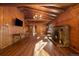 Cozy living room with wood paneling, stone fireplace, and rustic chandelier lighting at 121 Mary Beth Rd, Evergreen, CO 80439