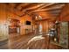 Open-concept living space with wood floors, stone fireplace, and seamless transition to the kitchen at 121 Mary Beth Rd, Evergreen, CO 80439