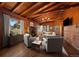 Inviting living room featuring wood paneling, vaulted ceiling, fireplace, and natural light at 121 Mary Beth Rd, Evergreen, CO 80439