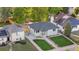 An aerial view of the house, highlighted with a manicured lawn and cozy backyard seating at 3541 Eudora St, Denver, CO 80207