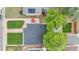 An aerial view showcases the home's roof, manicured lawn, patio with a red umbrella, and mature trees at 3541 Eudora St, Denver, CO 80207
