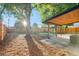 Spacious backyard featuring a covered patio, firepit, and wooden fence at 3541 Eudora St, Denver, CO 80207