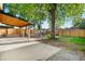 Spacious backyard featuring a covered patio, firepit, and wooden fence at 3541 Eudora St, Denver, CO 80207