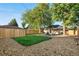 Large backyard with new grass, fire pit, and fence at 3541 Eudora St, Denver, CO 80207
