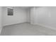 Finished basement room with neutral carpet and a small window at 3541 Eudora St, Denver, CO 80207