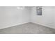 Finished basement room with neutral carpet and small egress windows at 3541 Eudora St, Denver, CO 80207