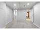 Finished basement featuring neutral carpet, lighting, and doorways to a closet and another room at 3541 Eudora St, Denver, CO 80207