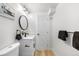 Updated bathroom with modern fixtures, vanity, and a round mirror, exuding contemporary elegance at 3541 Eudora St, Denver, CO 80207