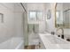 Bright bathroom with a modern vanity and shower with updated tile at 3541 Eudora St, Denver, CO 80207