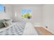Well-lit bedroom showcasing hardwood floors, fresh paint, and new window at 3541 Eudora St, Denver, CO 80207