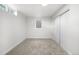 Neutral carpeted bedroom with a small window and a closet with white sliding doors at 3541 Eudora St, Denver, CO 80207