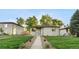 Charming exterior of this ranch-style home showcases a well-manicured lawn and inviting walkway at 3541 Eudora St, Denver, CO 80207