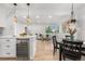 Open kitchen view with stainless steel wine fridge, stone countertops and view to the living area at 3541 Eudora St, Denver, CO 80207