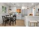 Modern kitchen featuring white cabinets, stainless steel appliances, and a breakfast bar at 3541 Eudora St, Denver, CO 80207