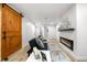 Bright living room with hardwood floors, electric fireplace, and wooden barn door adds charm to the space at 3541 Eudora St, Denver, CO 80207
