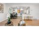 Open-concept living area with hardwood floors and views into the kitchen at 3541 Eudora St, Denver, CO 80207