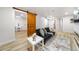 Cozy living room features hardwood floors, barn door, and an electric fireplace for a welcoming atmosphere at 3541 Eudora St, Denver, CO 80207