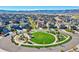 Aerial shot of a community featuring a playground with green space in the foreground and mountains in the background at 7267 Prairie Sage Pl, Littleton, CO 80125