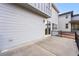 A concrete patio with black railings runs along the exterior, featuring light gray horizontal siding and a sliding glass door at 7267 Prairie Sage Pl, Littleton, CO 80125