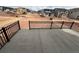 Concrete patio with black railing, overlooking a construction site and neighborhood, perfect for outdoor entertaining at 7267 Prairie Sage Pl, Littleton, CO 80125