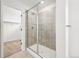 Modern bathroom with glass shower and neutral tile at 7267 Prairie Sage Pl, Littleton, CO 80125