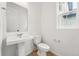 Contemporary half bathroom with modern fixtures, white walls, and new flooring at 7267 Prairie Sage Pl, Littleton, CO 80125