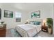 Bedroom with neutral bedding, decor and an area rug at 7267 Prairie Sage Pl, Littleton, CO 80125