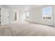 Spacious bedroom with carpet, two windows, and an en suite bathroom at 7267 Prairie Sage Pl, Littleton, CO 80125