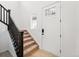 Inviting entryway with a staircase and a bright white front door at 7267 Prairie Sage Pl, Littleton, CO 80125