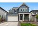 Charming two-story home with a two-car garage and a welcoming front porch at 7267 Prairie Sage Pl, Littleton, CO 80125