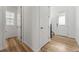 Hallway with neutral walls, doors, and wood-look flooring at 7267 Prairie Sage Pl, Littleton, CO 80125