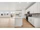 Modern kitchen featuring white cabinets, stainless steel appliances, and an island with quartz countertops at 7267 Prairie Sage Pl, Littleton, CO 80125