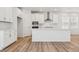 Kitchen with stainless steel appliances, white cabinets, quartz countertops, and center island at 7267 Prairie Sage Pl, Littleton, CO 80125