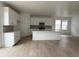 Bright, all-white kitchen featuring a large island, modern appliances, and sleek cabinetry, perfect for culinary enthusiasts at 7267 Prairie Sage Pl, Littleton, CO 80125