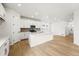Modern kitchen featuring white cabinets, stainless steel appliances, and an island with quartz countertops at 7267 Prairie Sage Pl, Littleton, CO 80125