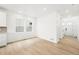 Bright living room featuring hardwood floors and a wall of large windows at 7267 Prairie Sage Pl, Littleton, CO 80125